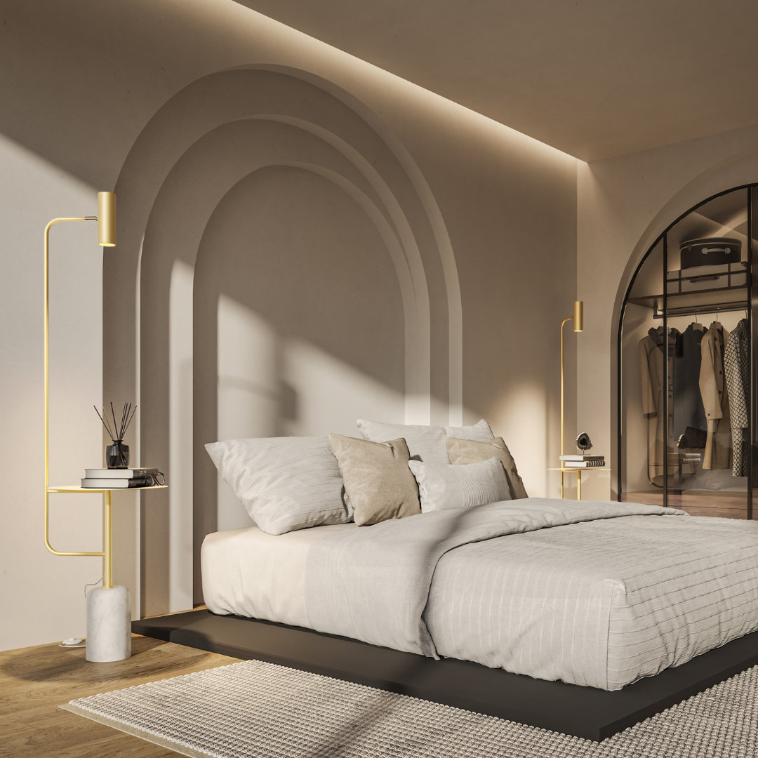 Gold floor lamp with table beside a bed in a bright bedroom