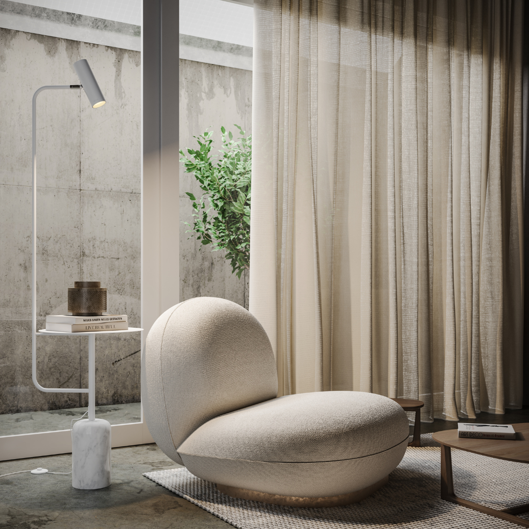 White floor lamp with side table beside an armchair