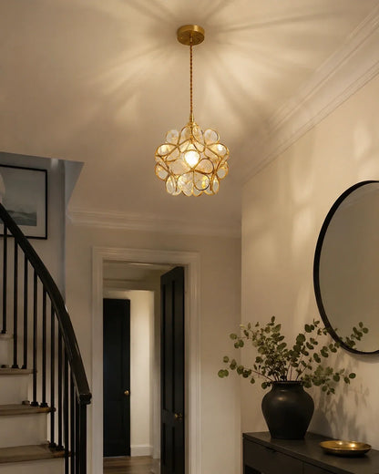 Floral glass petal pendant light with a warm metallic finish, illuminating a stylish hallway with a decorative, intricate petal-shaped design.