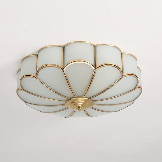 Flower-shaped frosted glass flush mount ceiling light with a brass frame