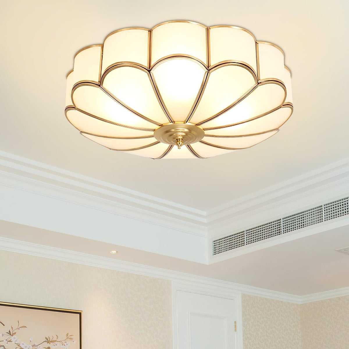 Brass flower-shaped glass ceiling light in a bedroom