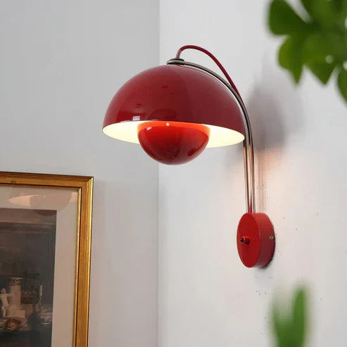 Red dome wall lamp casting light below the shade