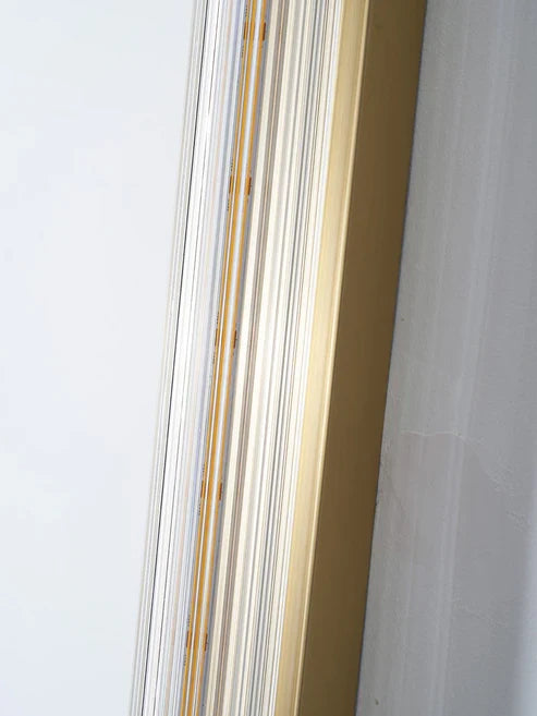Close-up of vertical fluted glass wall lamp