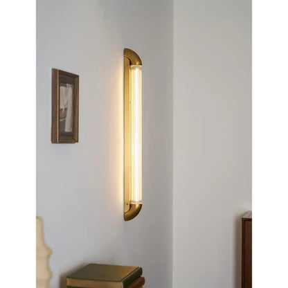 Fluted wall light beside a framed picture
