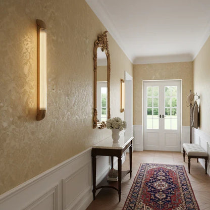 Glass tube wall light in a hallway
