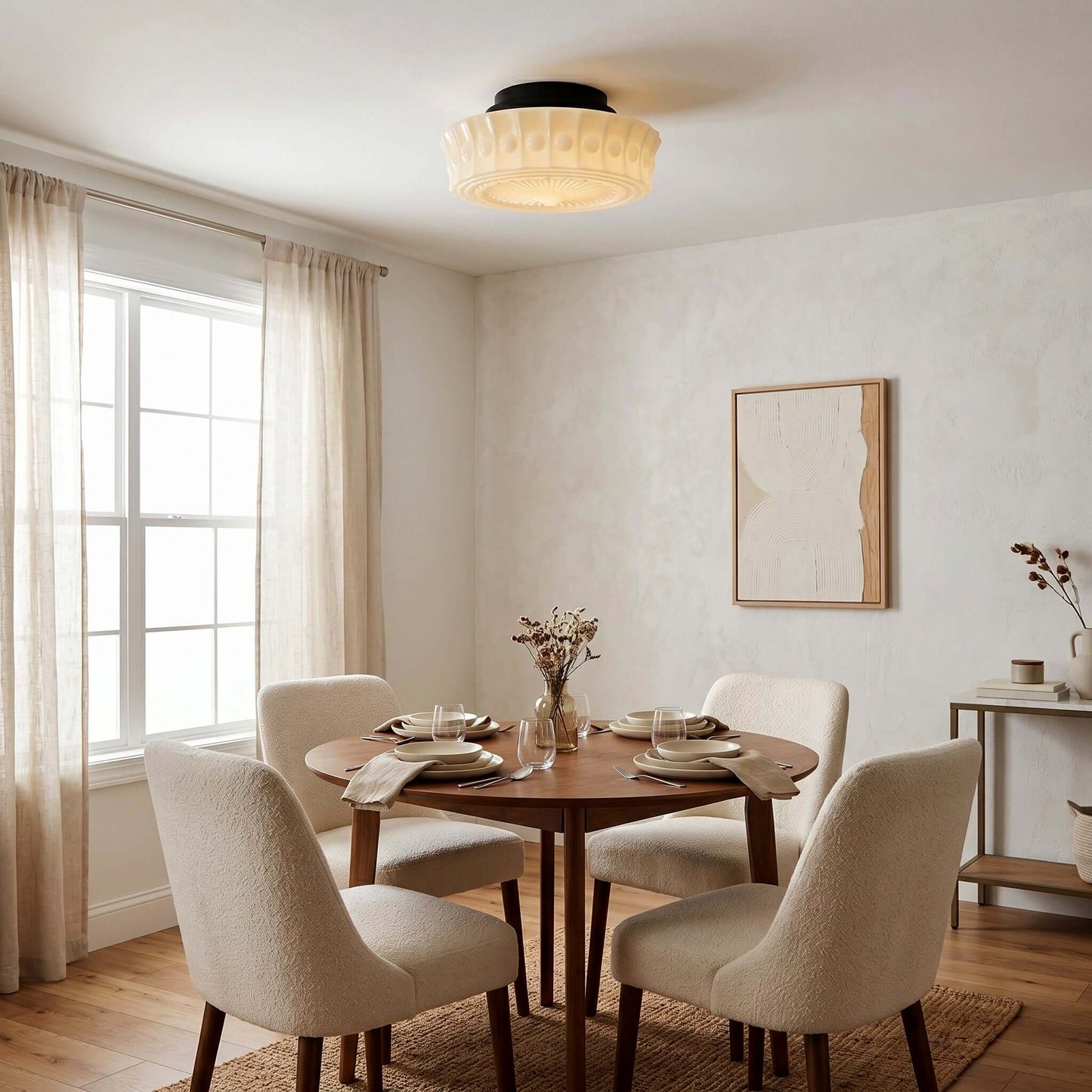 French vintage style flushmount ceiling fixture with a textured glass shade installed in a bright, neutral dining room with a round wooden table.