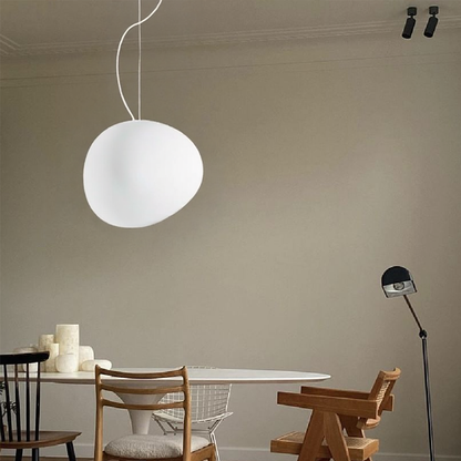 White glass pendant beside a dining table and chair
