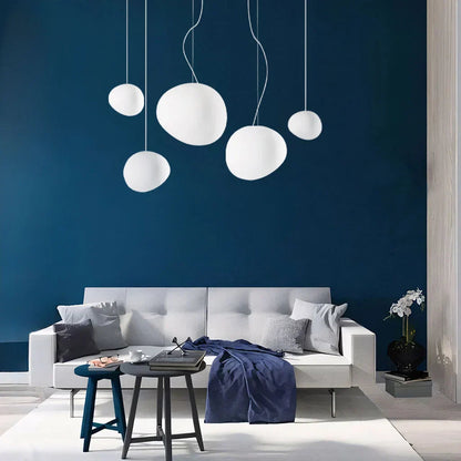 Glass globe pendant lights hanging at different heights