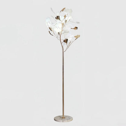 A modern ginkgo leaf LED floor lamp featuring a slender gold-coloured stem, a round marble base, and delicate white and gold leaf-shaped shades.