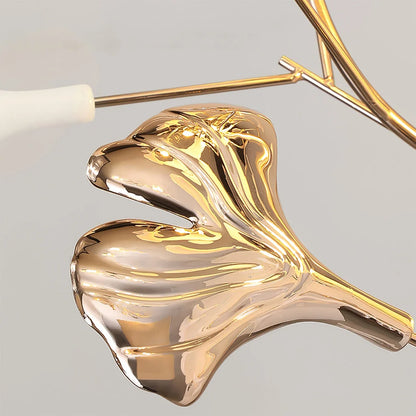 Close-up of a shiny gold ginkgo leaf detail on the Ginkgo Leaf LED Floor Lamp, showcasing the reflective metallic finish and delicate branch design.