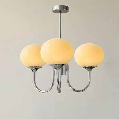 Three-light pendant ceiling light featuring a polished chrome frame and spherical cream glass shades, providing elegant modern interior lighting.