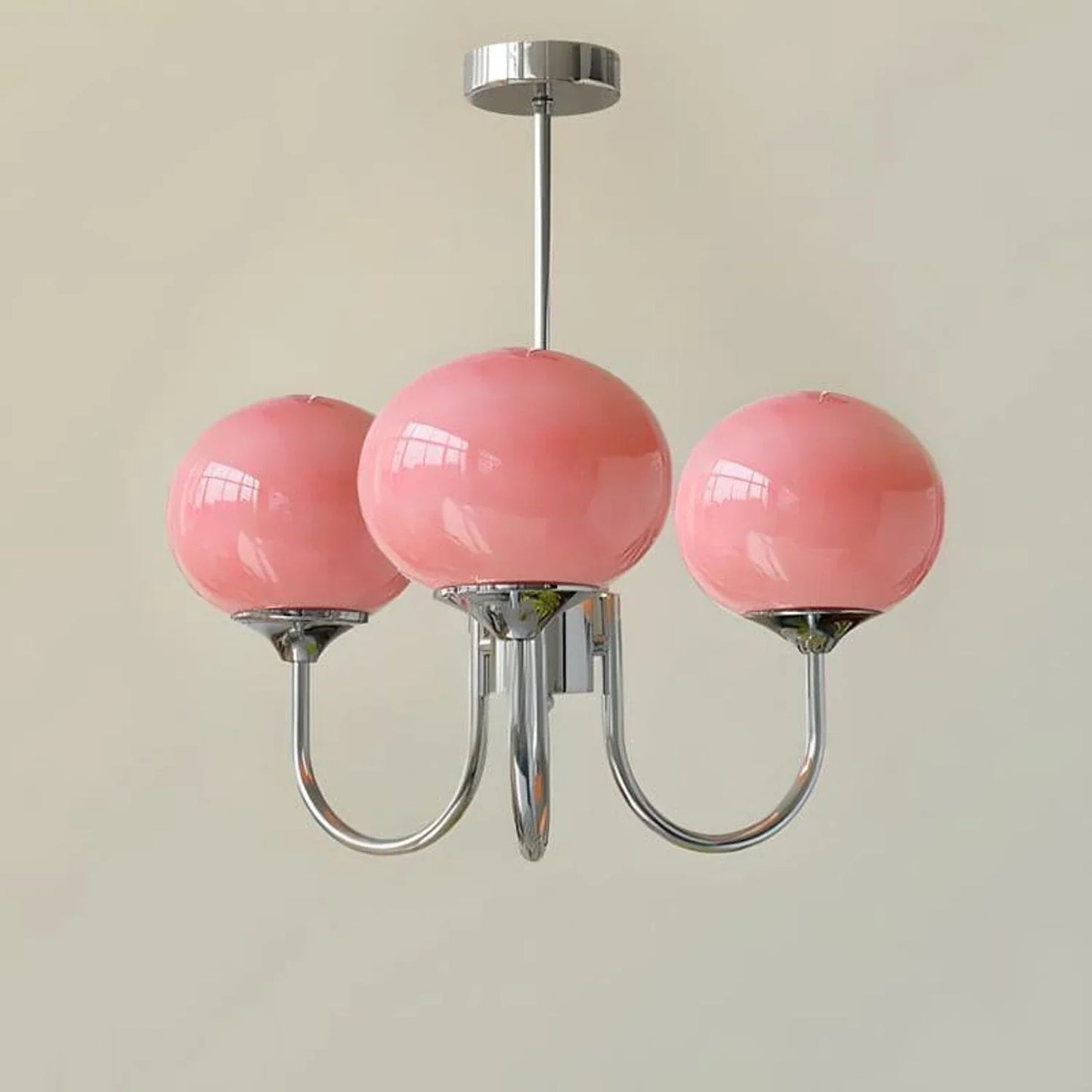 Modern 3-light pendant ceiling light featuring three glossy pink glass ball shades suspended from a polished chrome metal frame, 46cm diameter.