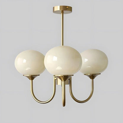Three-light modern pendant ceiling light featuring smooth cream glass globes suspended from a sleek copper-toned metal frame against a plain background.