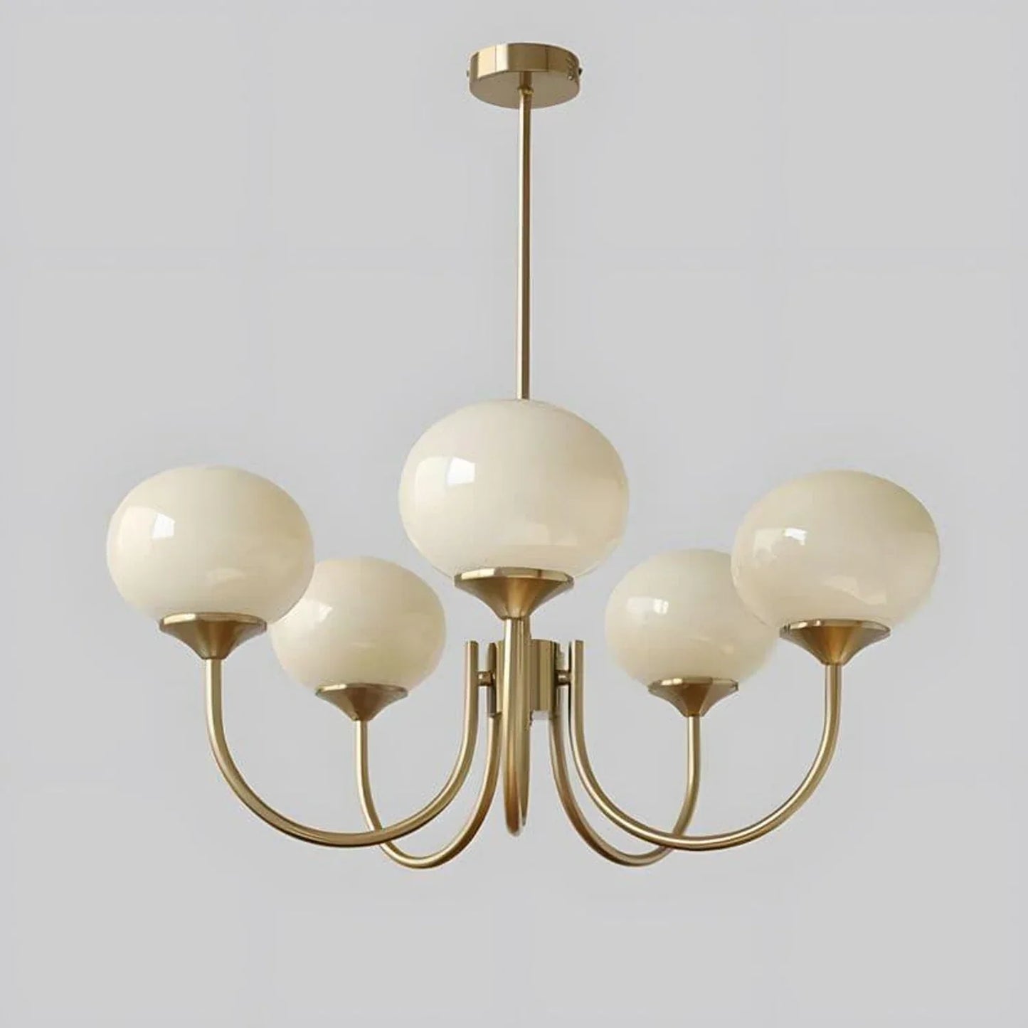 Modern 5-light pendant ceiling light featuring a copper finish frame with five cream-coloured glass ball shades, measuring 67cm in diameter.