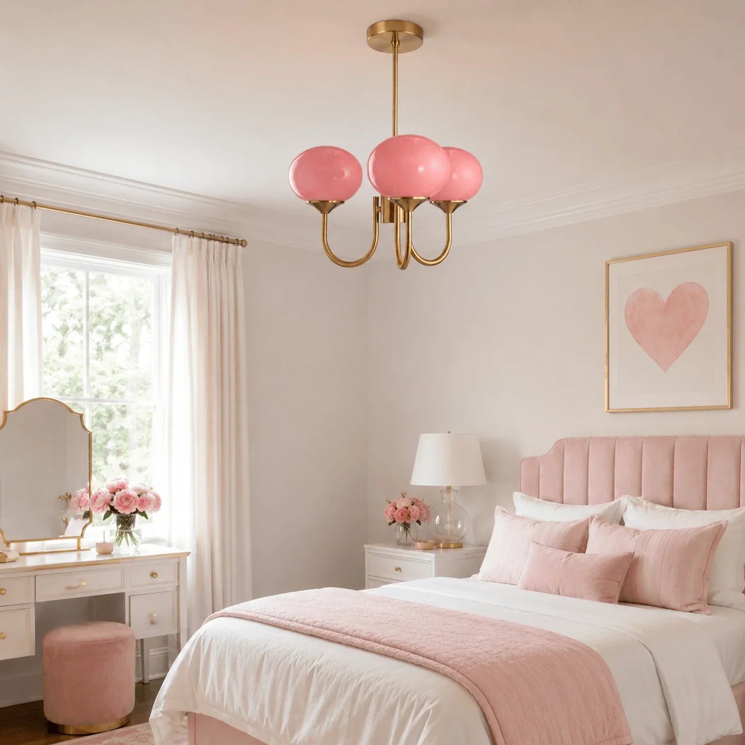 A modern gold pendant ceiling light featuring three pink glass ball globes, hanging in a stylishly decorated pink and white bedroom.