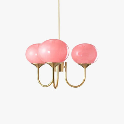 Modern glass ball pendant light featuring three pink glass globes on curved gold-coloured metal arms, designed for ceiling suspension.