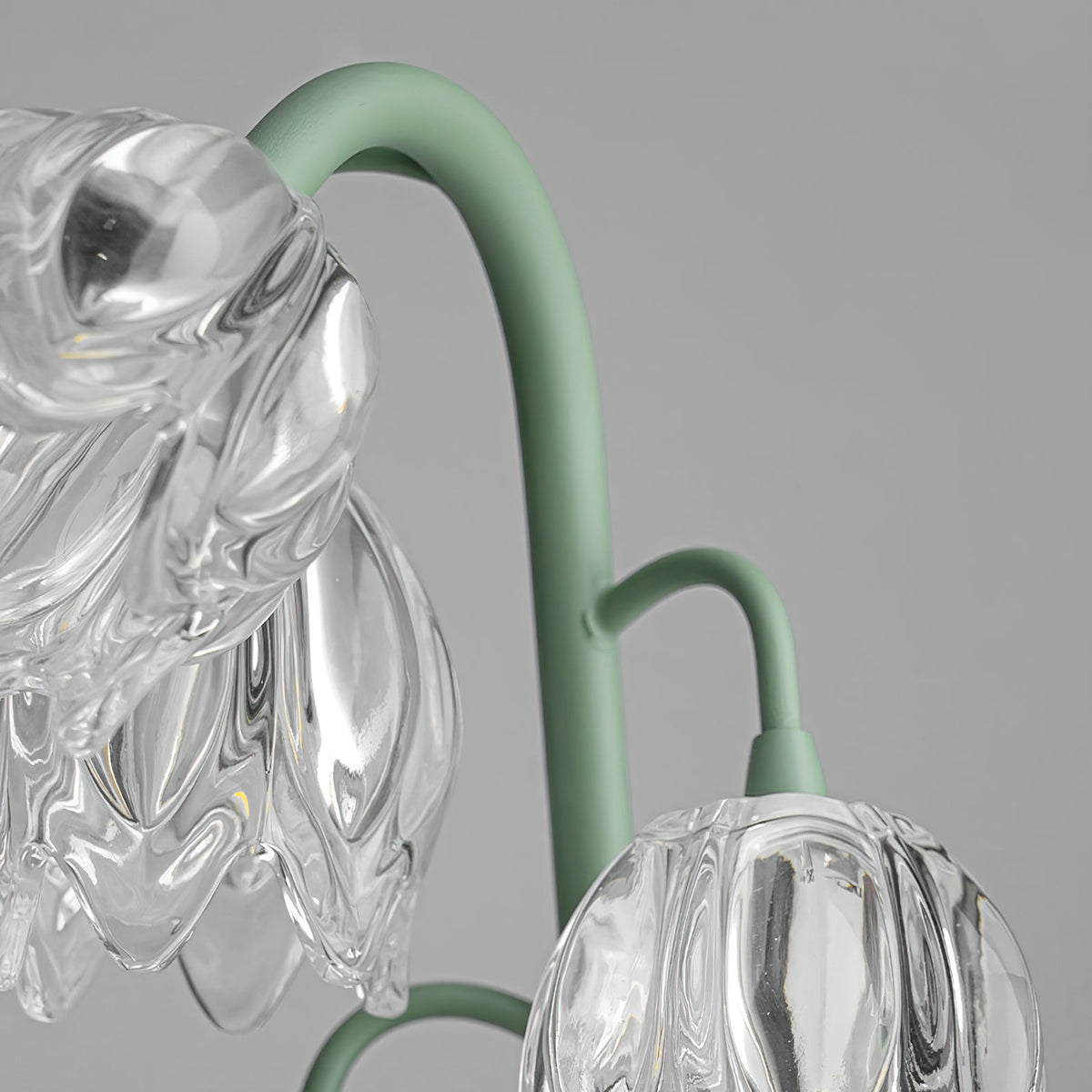 Glass blossoms hanging from curved green metal stems
