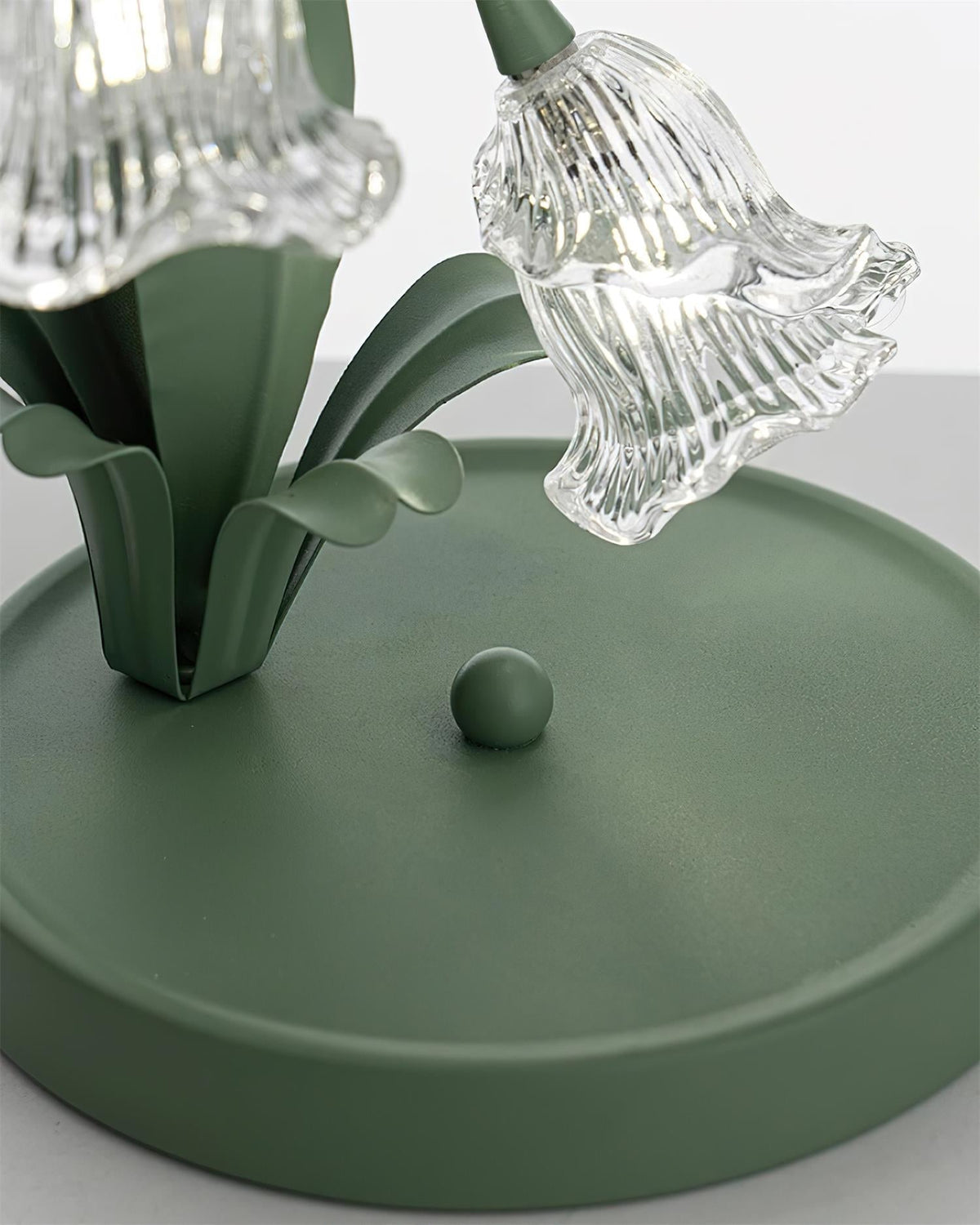 Green metal base and ribbed glass blossom shade