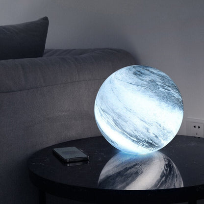 Cool glowing glass moon table lamp on a side table