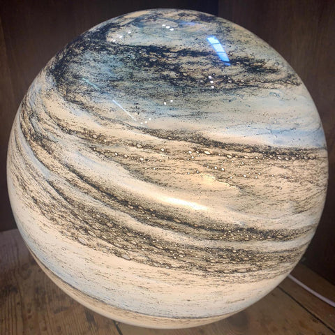 Close-up of glass moon lamp with natural cosmic patterns