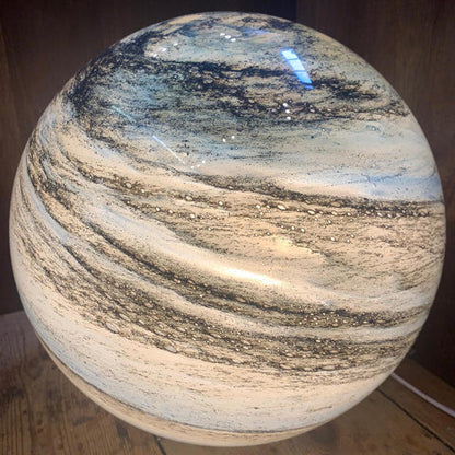 Close-up of glass moon lamp with natural cosmic patterns