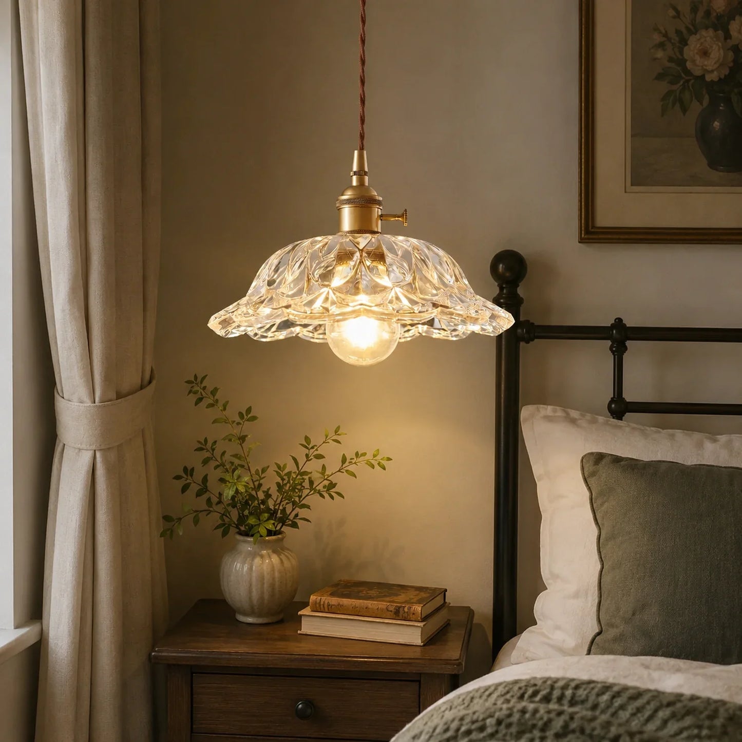Large glass pendant light with a textured floral shade and brass fitting, hanging above a bedside table in a cosy bedroom setting.