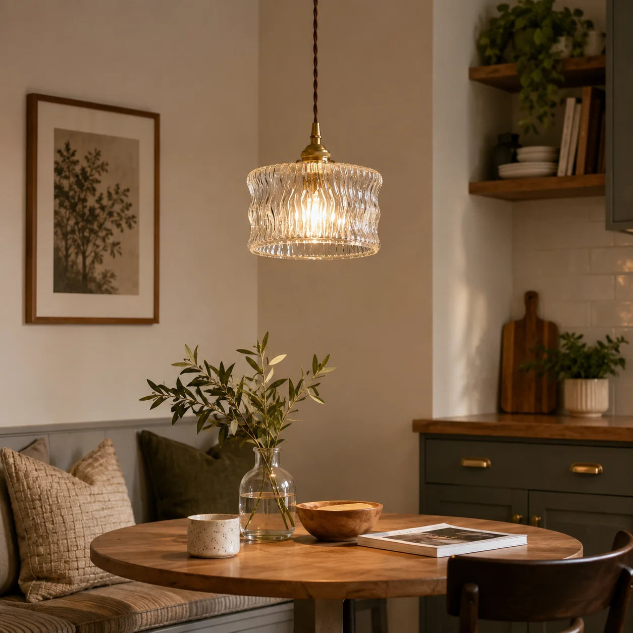 Modern glass pendant light with a textured shade and adjustable cord, illuminating a cosy dining area with a wooden table and comfortable seating.