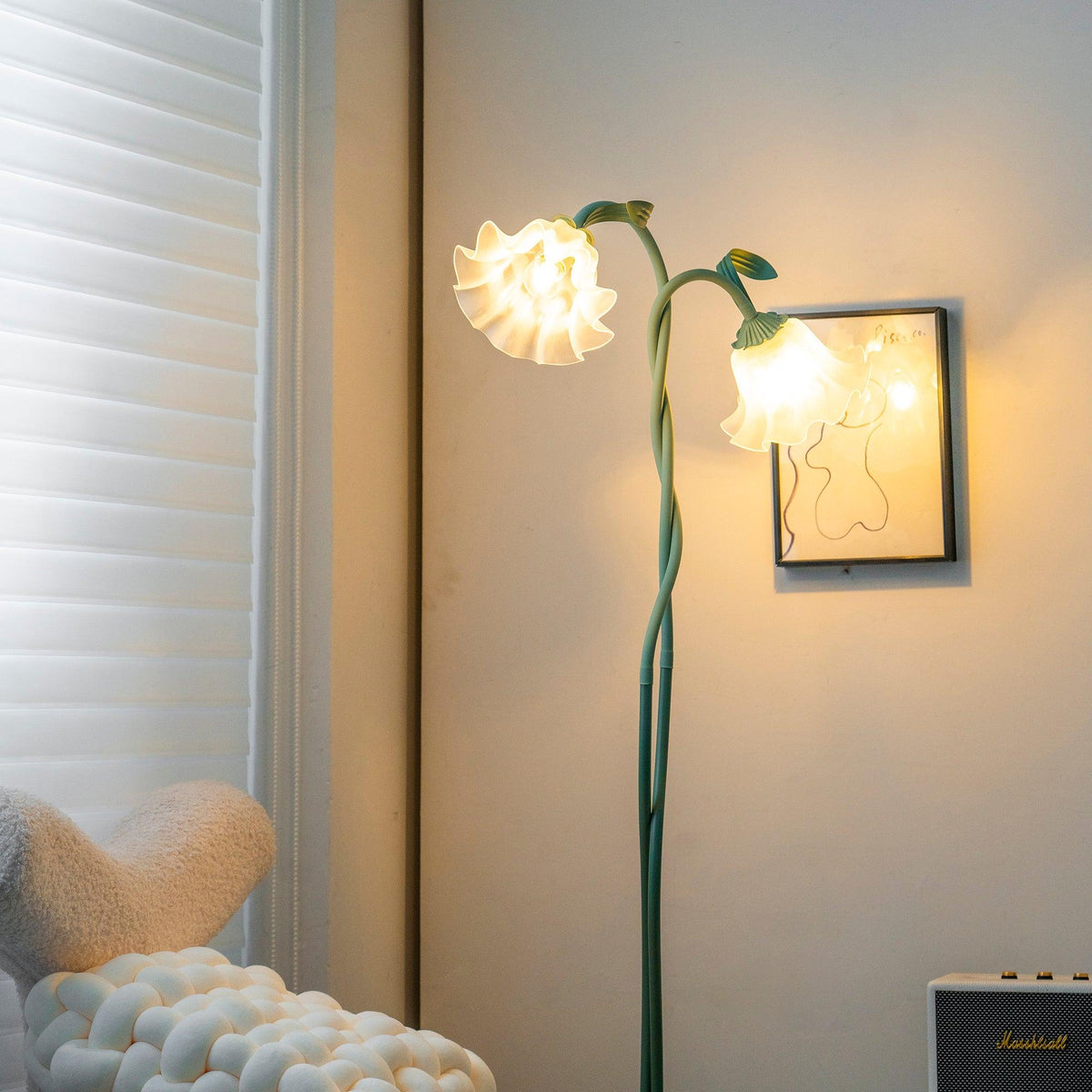 Two-head green flower floor lamp in a reading corner