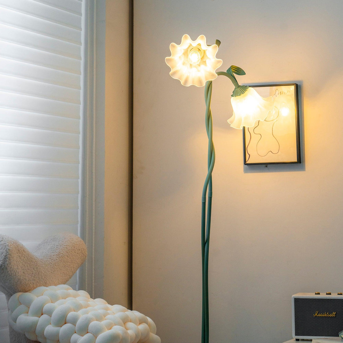 Close-up of illuminated floral shades beside artwork