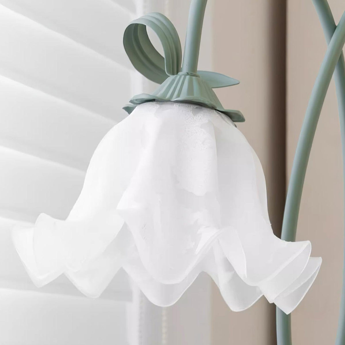 Close-up of a white flower shade and green leaf detail