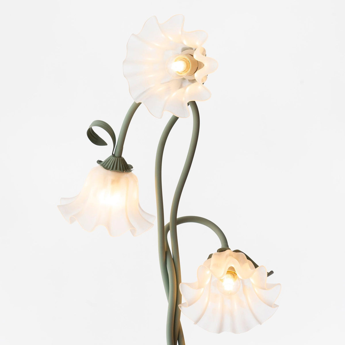 Angled view of the three white flower shades