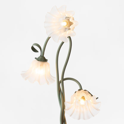 Angled view of the three white flower shades