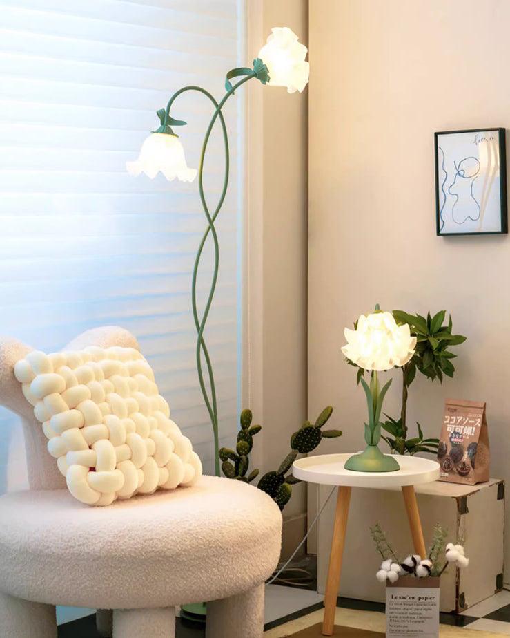 Two-head green flower lamp in a sunlit reading corner