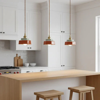 Red ceramic pendants above a kitchen island