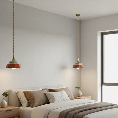 Hand-painted pendants beside a bed