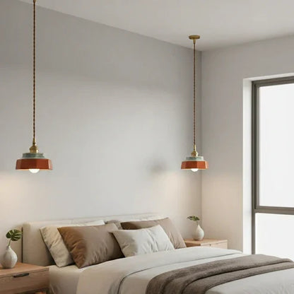 Hand-painted pendants beside a bed