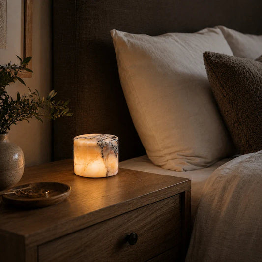 Natural marble cylinder lamp on a bedside table