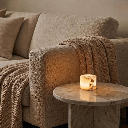 Compact marble cylinder lamp beside an armchair