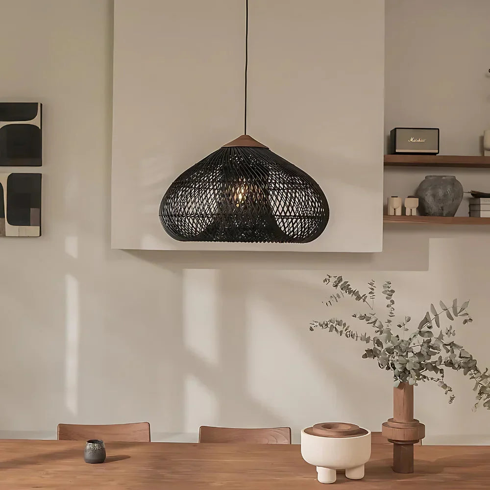 Black rattan dome pendant above a dining table