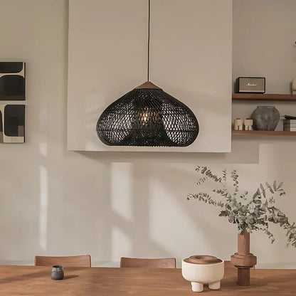 Black rattan dome pendant above a dining table