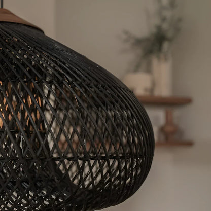 Black woven shade with illuminated bulb inside