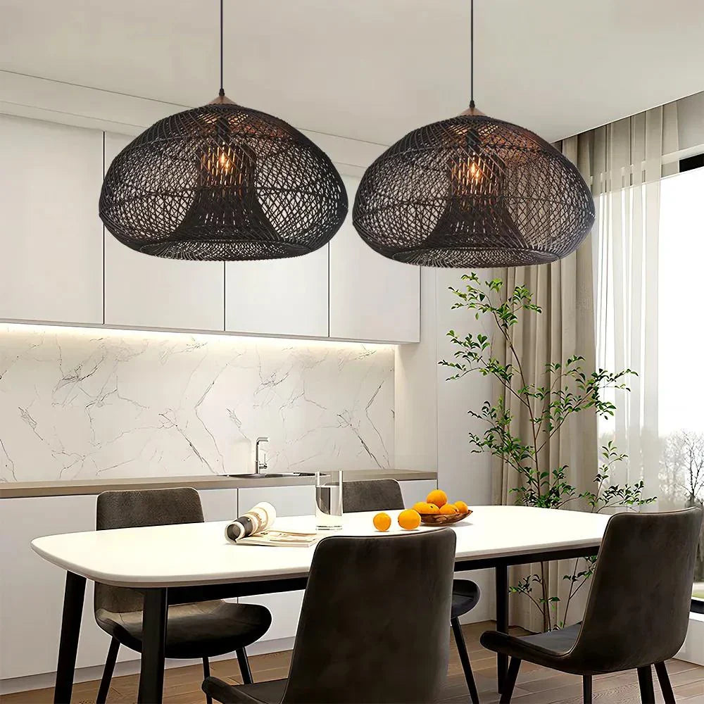 Two black rattan dome pendants above a table