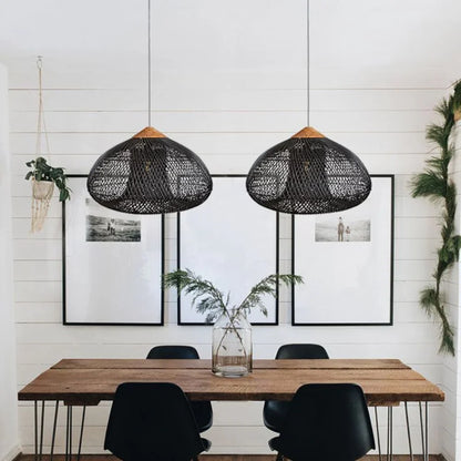Two black rattan pendants above a wooden table
