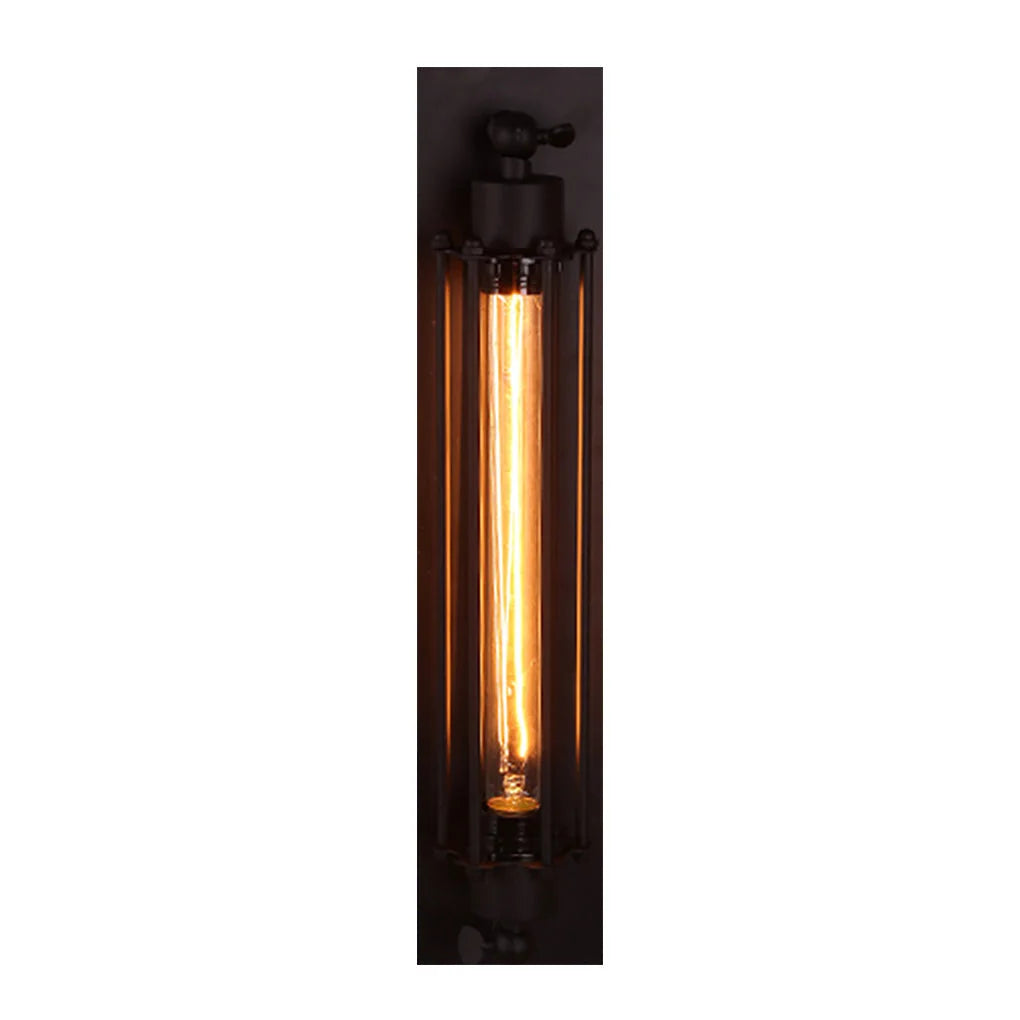 Industrial iron wall sconce featuring a black cage design with a warm glowing vintage-style tubular filament bulb for indoor loft-style lighting.