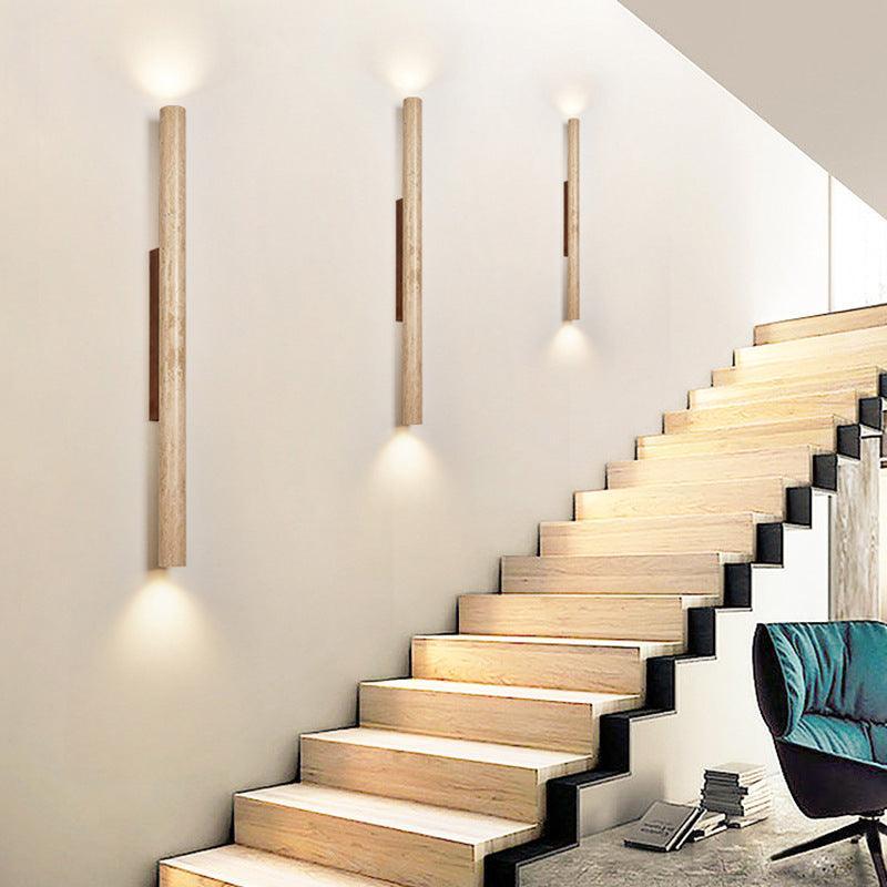 Row of travertine wall lights along a staircase