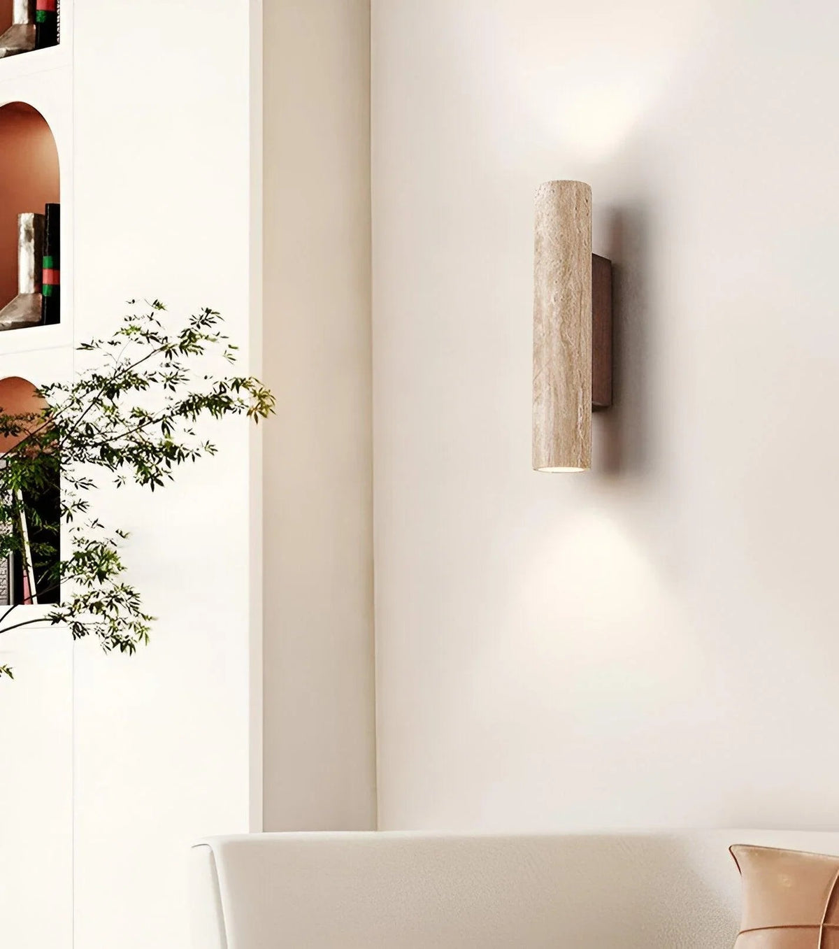 Travertine wall light with dark wood backplate above a console