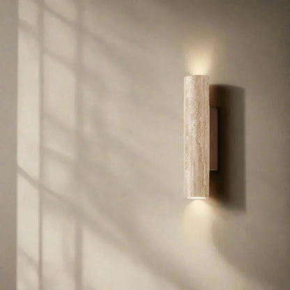 Natural stone wall light casting light above and below