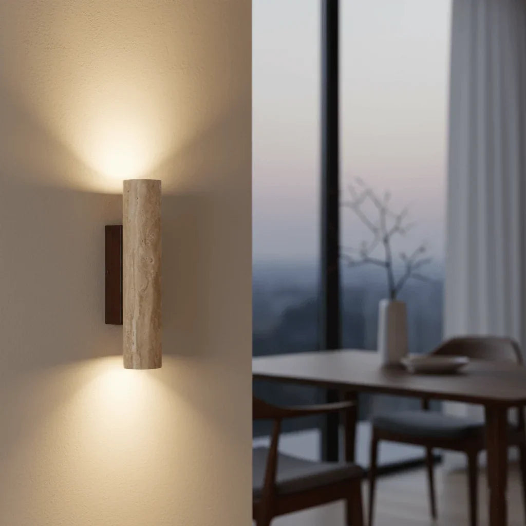 Travertine wall light illuminating a wall beside a window