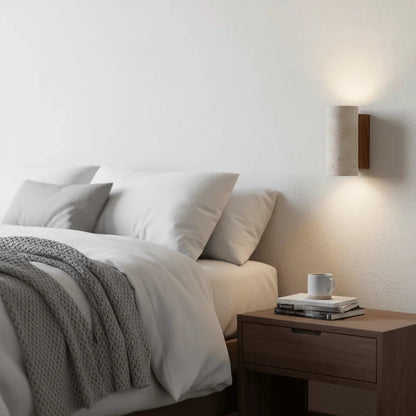 Warm up-and-down wall light beside a bedroom table