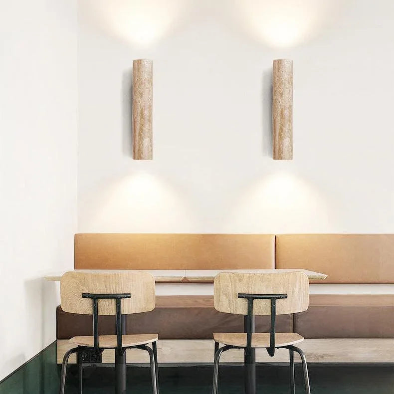 Pair of travertine wall lights above a dining bench